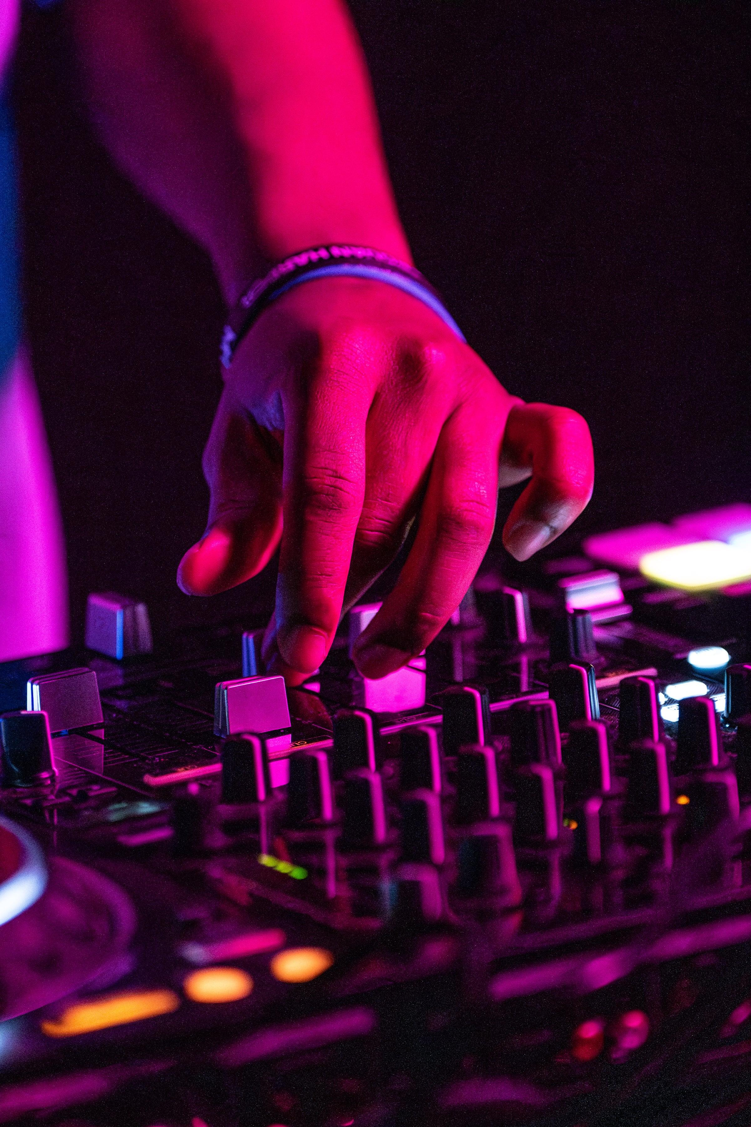 MH working the mixer faders under magenta stage light