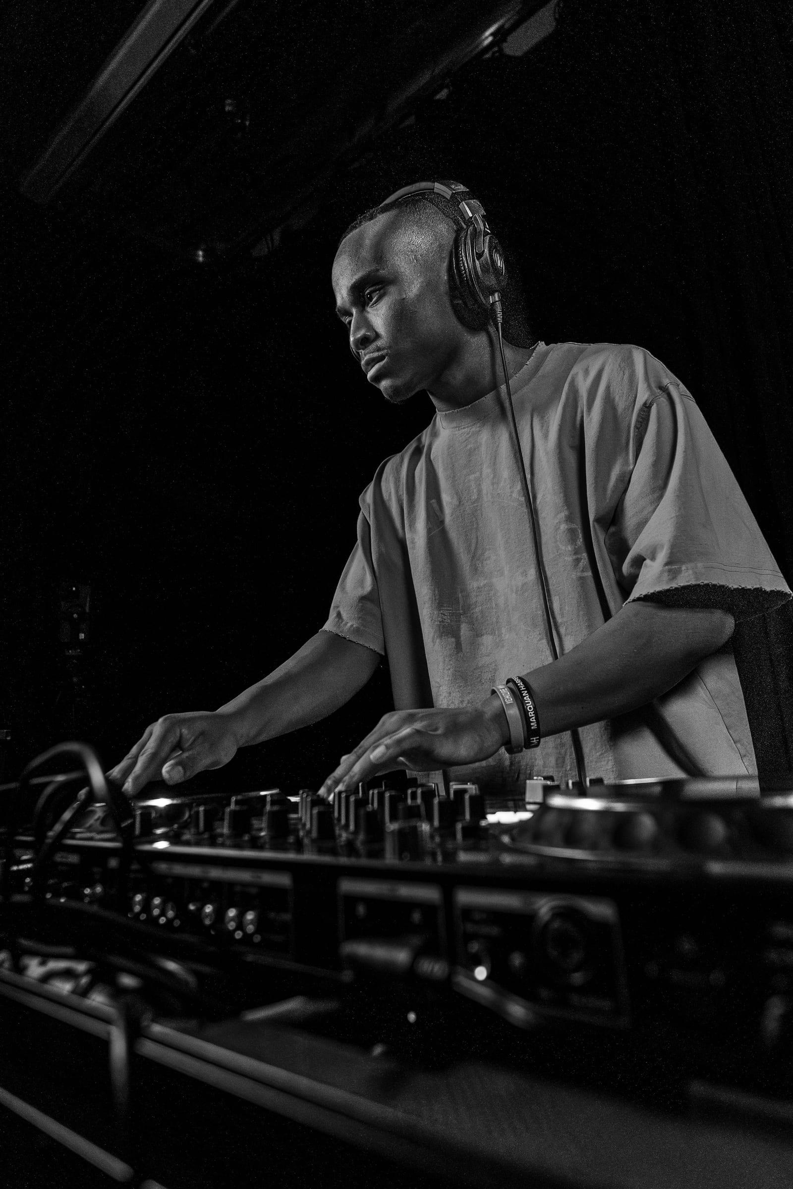Black-and-white wide frame of MH at the decks in a dark room
